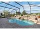 A lovely screened-in pool features a rock waterfall and stone surround, perfect for outdoor relaxation at 2746 Windsorgate Ln, Orlando, FL 32828