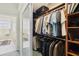 Large walk-in closet with ample storage with connecting door to bathroom at 2746 Windsorgate Ln, Orlando, FL 32828