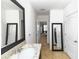 Hall bathroom featuring granite sink, tile floor and a large decorative mirror at 296 Inman Blvd, Winter Haven, FL 33881