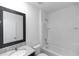 Bright white bathroom featuring a granite sink and a shower and tub combo at 296 Inman Blvd, Winter Haven, FL 33881