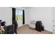 Bedroom with neutral armchair, window view, and modern computer set up at 296 Inman Blvd, Winter Haven, FL 33881