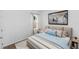 Bright bedroom featuring a comfortable bed with a blue blanket and pillows at 296 Inman Blvd, Winter Haven, FL 33881