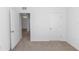 Unfurnished bedroom featuring carpet flooring and a double door closet at 296 Inman Blvd, Winter Haven, FL 33881