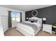 Stylish bedroom featuring a dark accent wall, a plush bed, and bright window with a view at 296 Inman Blvd, Winter Haven, FL 33881