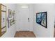 Bright entryway with decorative wall art and a white door with a transom window at 296 Inman Blvd, Winter Haven, FL 33881