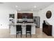 Open kitchen with granite countertops, stainless steel appliances, dark cabinets, and an eat-in island at 296 Inman Blvd, Winter Haven, FL 33881