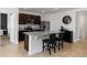 Bright, modern kitchen featuring granite countertops, stainless steel appliances, and dark wood cabinetry at 296 Inman Blvd, Winter Haven, FL 33881