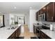 Granite countertops and stainless steel appliances and dark cabinetry in an airy, open kitchen at 296 Inman Blvd, Winter Haven, FL 33881
