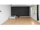 Spacious room featuring a modern accent wall and a window, complete with neutral tile flooring throughout at 296 Inman Blvd, Winter Haven, FL 33881