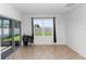 Bright living room with sliding glass doors to the backyard, complemented by neutral tile flooring at 296 Inman Blvd, Winter Haven, FL 33881