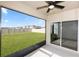Covered patio features a ceiling fan and a screened-in porch with a view of the spacious backyard at 296 Inman Blvd, Winter Haven, FL 33881