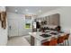 Modern kitchen features quartz countertops, stainless steel appliances, and a cozy breakfast bar at 3060 Skyline Loop, Kissimmee, FL 34758