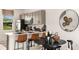Modern kitchen with stainless steel appliances, breakfast bar, and adjacent dining area provides inviting, eat-in space at 3060 Skyline Loop, Kissimmee, FL 34758