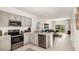 Modern kitchen with stainless steel appliances and an open floor plan at 3064 Skyline Loop, Kissimmee, FL 34758