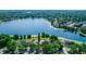 Aerial view of property on the lake, highlighting its prime waterfront location and neighborhood at 3065 Bridgehampton Ln, Orlando, FL 32812