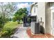 Backyard view with a screened patio, leading to a lush lawn and scenic lake at 3065 Bridgehampton Ln, Orlando, FL 32812