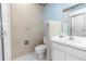 Neutral-toned bathroom featuring floral wallpaper, a white vanity, and a toilet at 3065 Bridgehampton Ln, Orlando, FL 32812