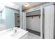 Bathroom featuring dual closets, white vanity, and floral wallpaper at 3065 Bridgehampton Ln, Orlando, FL 32812