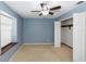 Blue bedroom featuring a window and a closet at 3065 Bridgehampton Ln, Orlando, FL 32812