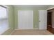 Green bedroom with a closet and window at 3065 Bridgehampton Ln, Orlando, FL 32812