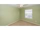 Carpeted bedroom features a ceiling fan and a window with mini blinds at 3065 Bridgehampton Ln, Orlando, FL 32812