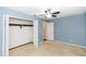 Blue bedroom with carpet flooring, a ceiling fan, and a closet at 3065 Bridgehampton Ln, Orlando, FL 32812