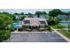 Exterior view of a charming community clubhouse with a pool, tennis court, and ample parking at 3065 Bridgehampton Ln, Orlando, FL 32812