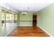 Bright dining room with hardwood floors, chandelier, sliding glass doors, and kitchen access at 3065 Bridgehampton Ln, Orlando, FL 32812
