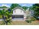 Charming home with a screened patio and a view of the surrounding greenery and lake at 3065 Bridgehampton Ln, Orlando, FL 32812