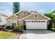Charming single-story home features a two-car garage, brick accents, and well-maintained landscaping at 3065 Bridgehampton Ln, Orlando, FL 32812