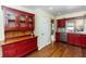 Traditional kitchen features granite countertops, stainless steel appliances, red cabinets, and hardwood floors at 3065 Bridgehampton Ln, Orlando, FL 32812