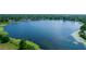 Scenic aerial view of a beautiful lake surrounded by lush greenery and residential homes at 3065 Bridgehampton Ln, Orlando, FL 32812