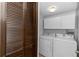 Functional laundry room features washer, dryer, and built-in cabinets for storage at 3065 Bridgehampton Ln, Orlando, FL 32812