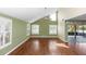 Spacious living room boasts vaulted ceilings, wood floors, large windows, and access to a screened lanai at 3065 Bridgehampton Ln, Orlando, FL 32812