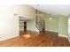Spacious living room with hardwood floors, vaulted ceilings, and views to the dining area and stairs at 3065 Bridgehampton Ln, Orlando, FL 32812