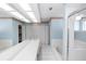 A well-lit bathroom shows a double sink, tub, stand up shower, and linen closet at 3065 Bridgehampton Ln, Orlando, FL 32812