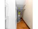 A small utility room with wire shelving features a hot water heater set on a stained hardwood floor at 3065 Bridgehampton Ln, Orlando, FL 32812