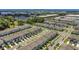 Community aerial view showing neat rows of townhomes, landscaping, and nearby commercial areas at 3335 Azolla St, Orlando, FL 32808