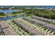Aerial view of townhome community, showcasing lush landscaping, pond and convenient street parking at 3335 Azolla St, Orlando, FL 32808