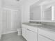 Modern bathroom with a glass-enclosed shower and a white vanity with speckled countertop at 3335 Azolla St, Orlando, FL 32808