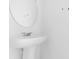 Minimalist bathroom featuring a pedestal sink and a sleek, round mirror at 3335 Azolla St, Orlando, FL 32808