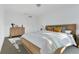 Bright primary bedroom featuring a wooden bed frame, modern dresser, and neutral decor at 3335 Azolla St, Orlando, FL 32808
