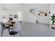 Bright dining area features a modern table set near the open kitchen and staircase at 3335 Azolla St, Orlando, FL 32808