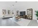 Bright living room with a large window, contemporary furnishings, and neutral tones at 3335 Azolla St, Orlando, FL 32808