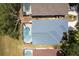 Aerial view of a home with a screened pool and a well-maintained roof at 339 Holborn Loop, Davenport, FL 33897