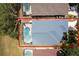 Aerial view of a home with a screened pool and a well-maintained roof at 339 Holborn Loop, Davenport, FL 33897