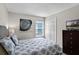 Cozy bedroom featuring a comfortable bed, a window for natural light, and a dresser with a television at 339 Holborn Loop, Davenport, FL 33897