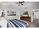 This primary bedroom features a ceiling fan and ensuite bathroom at 339 Holborn Loop, Davenport, FL 33897