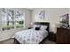 Cozy bedroom with a large window for natural light, a comfortable bed, and neutral decor at 339 Holborn Loop, Davenport, FL 33897