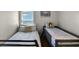 Shared bedroom featuring two twin beds, each with unique decorative pillows and individual reading lamps at 339 Holborn Loop, Davenport, FL 33897